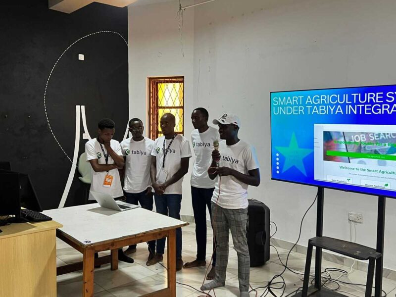 Team presents a project in front of a screen titled "Smart Agriculture Under Tabiya."