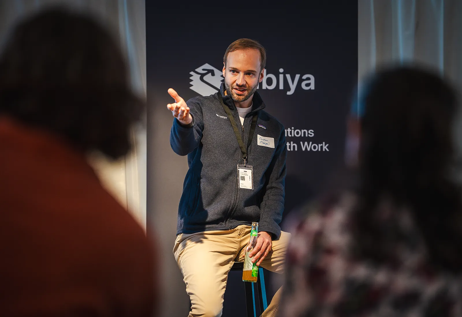 Facilitator leads a discussion at a Tabiya event, pointing while engaging the audience.